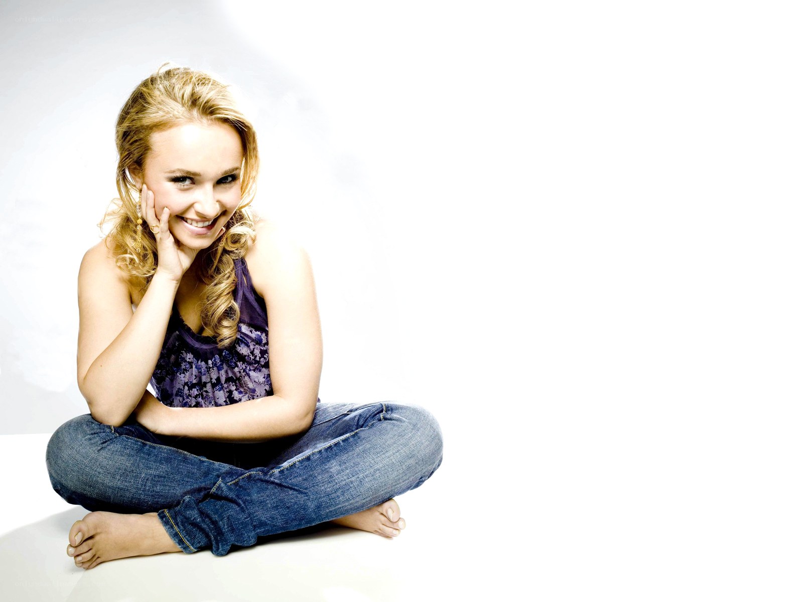 woman sitting cross-legged smiling