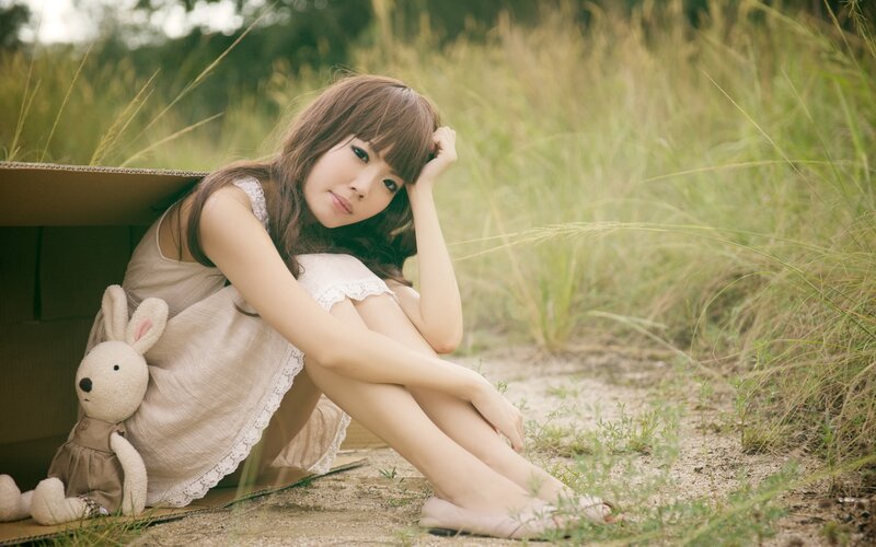 woman sitting in a cardboard box