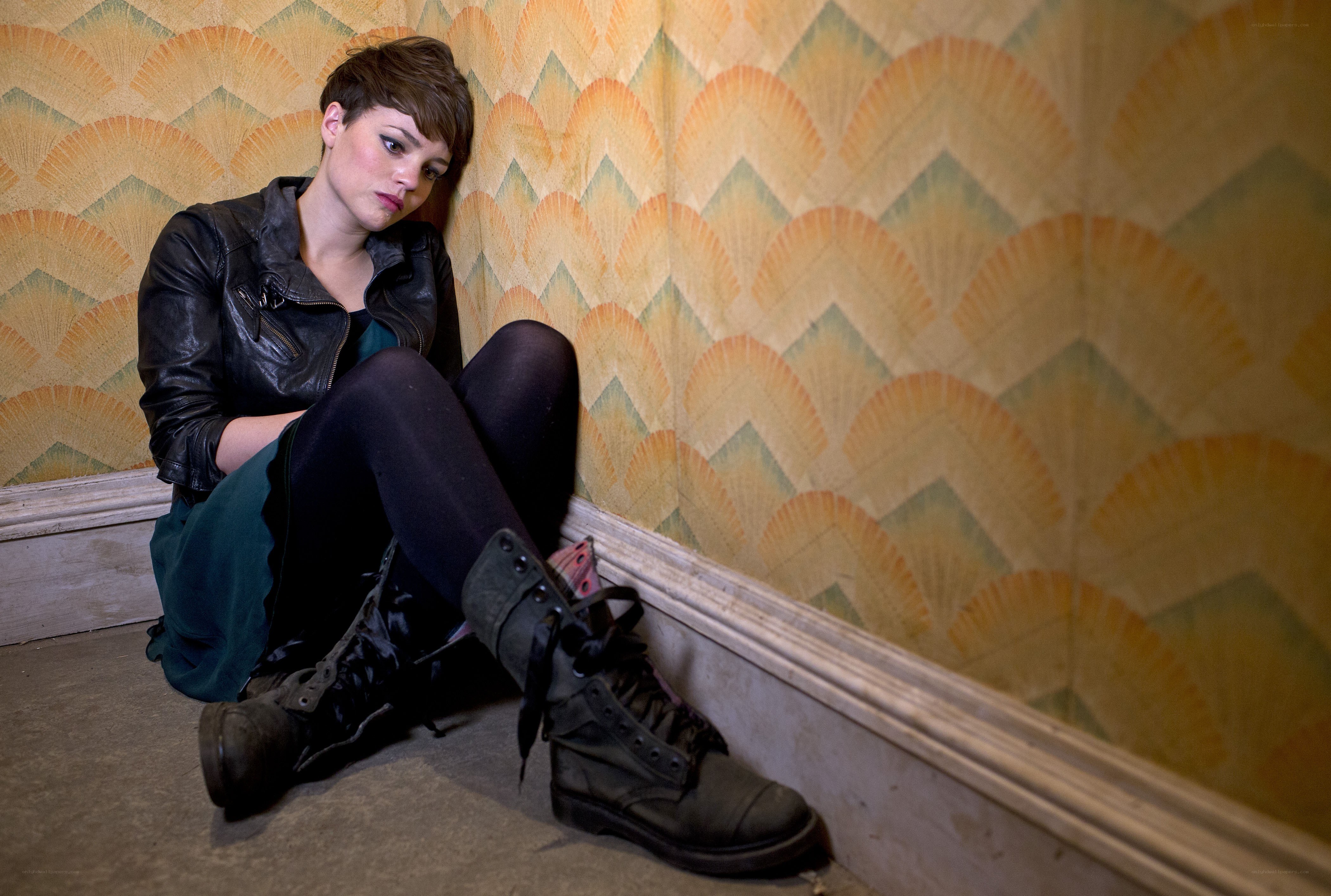 woman sitting in a corner