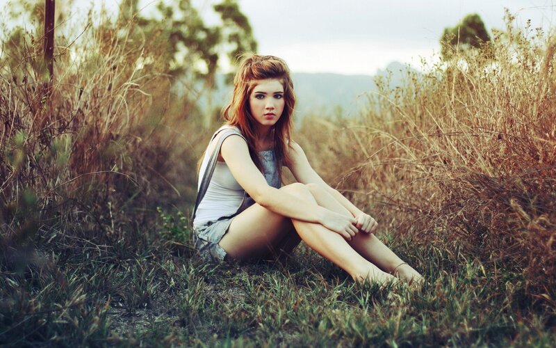 woman sitting in a field