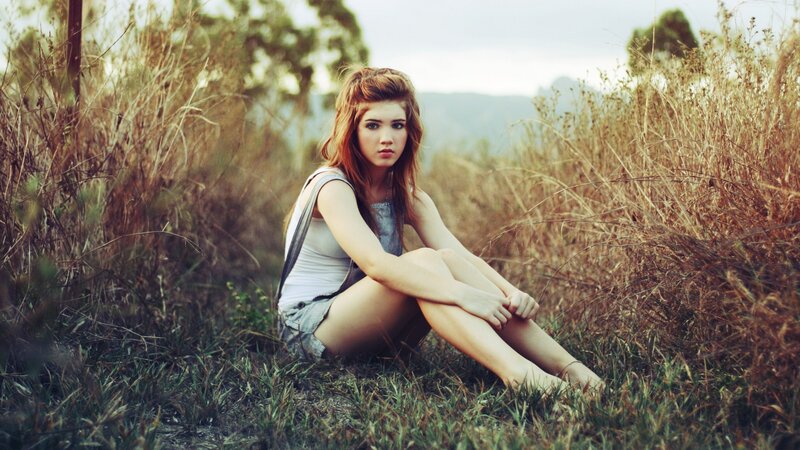 woman sitting in a field