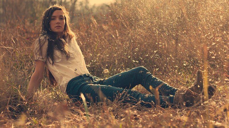woman sitting in a field