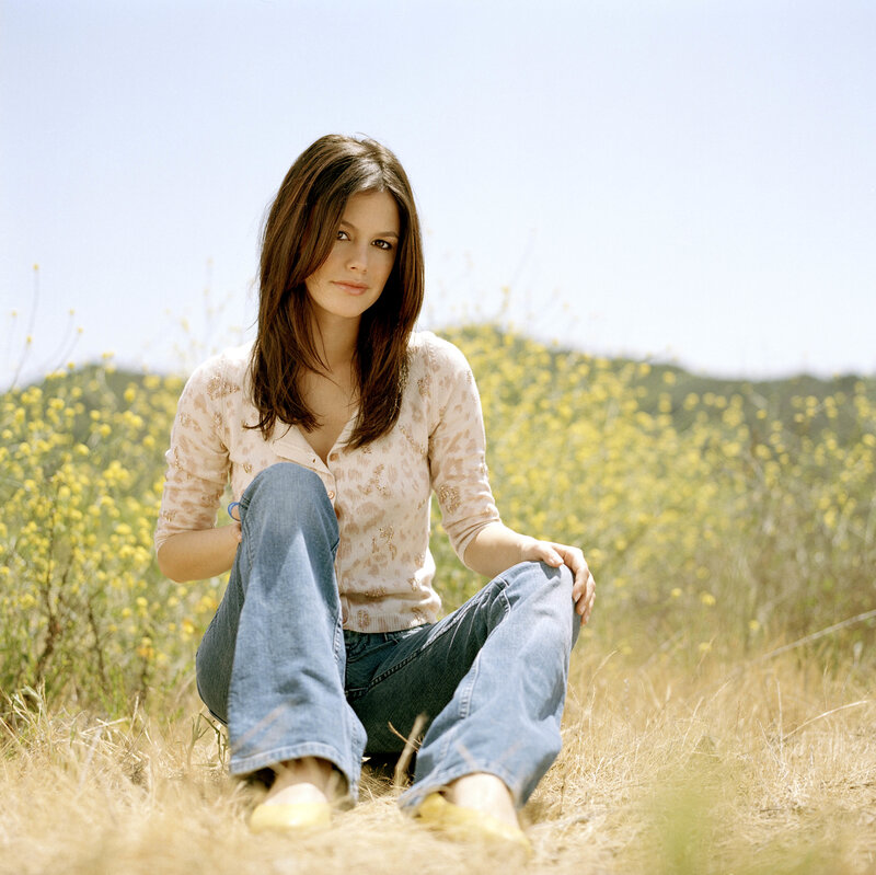 woman sitting in a field of flowers