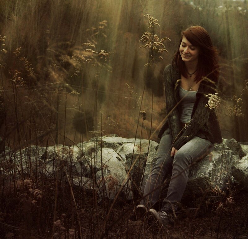 woman sitting in a forest
