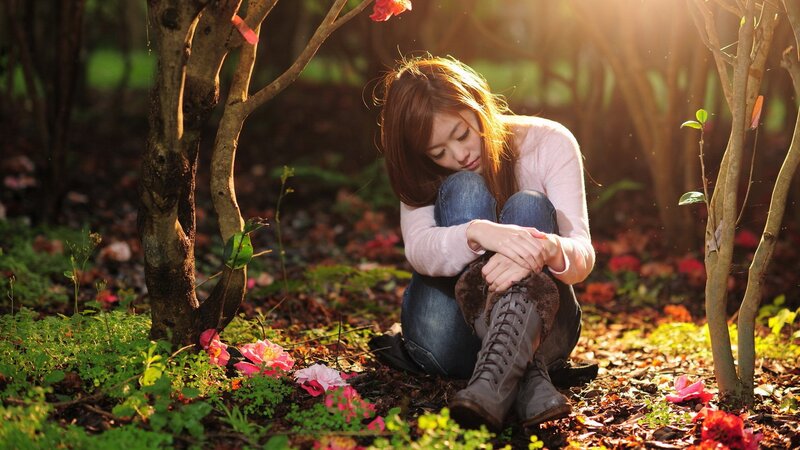Woman sitting in a garden