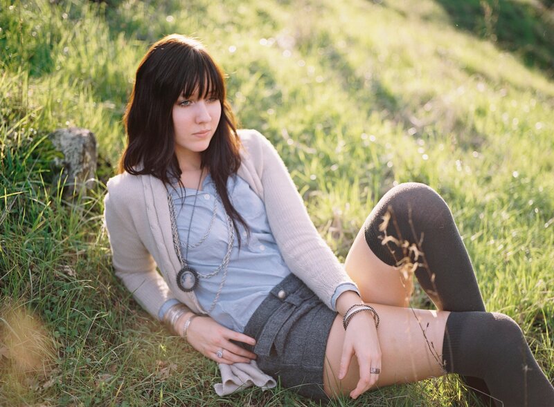 woman sitting in a grassy field