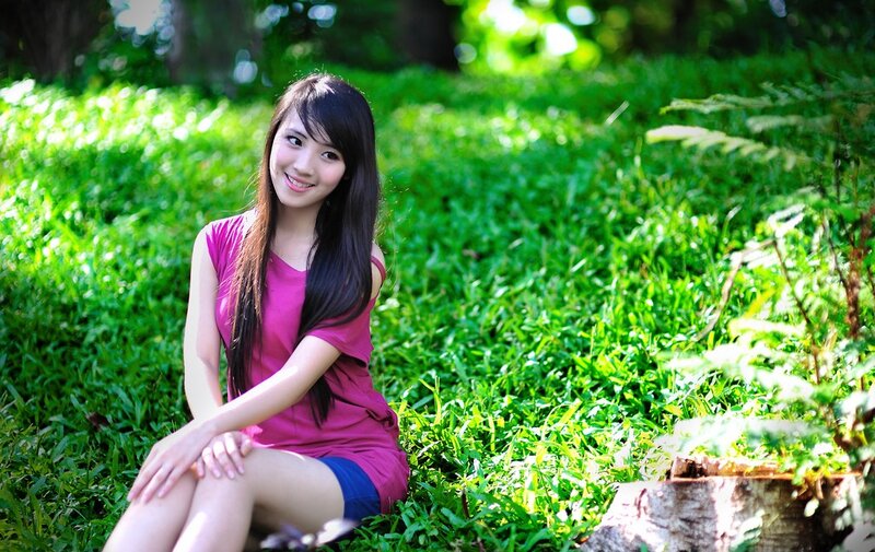 woman sitting in a grassy park