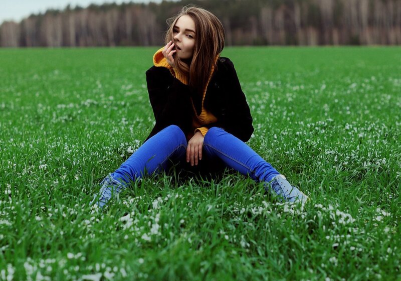 woman sitting in a green field