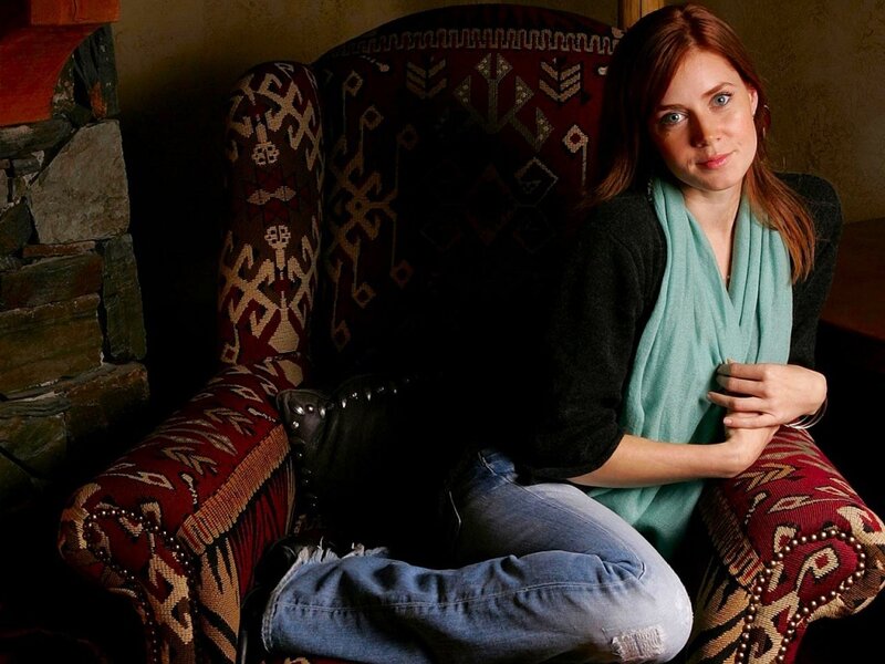 woman sitting in a patterned armchair