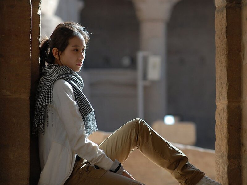 woman sitting in a sunlit corridor