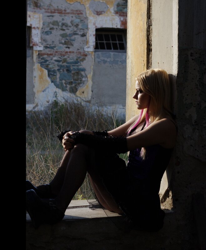 woman sitting in abandoned building