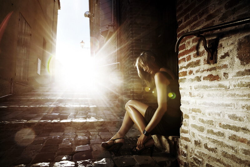 Woman Sitting in Alley