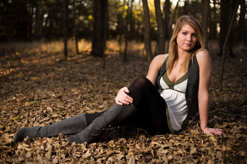 woman sitting in autumn forest