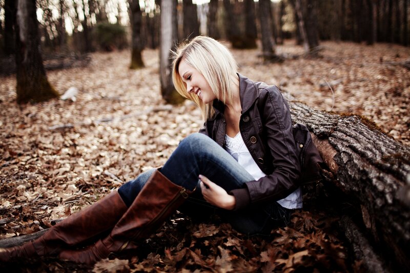woman sitting in autumn forest