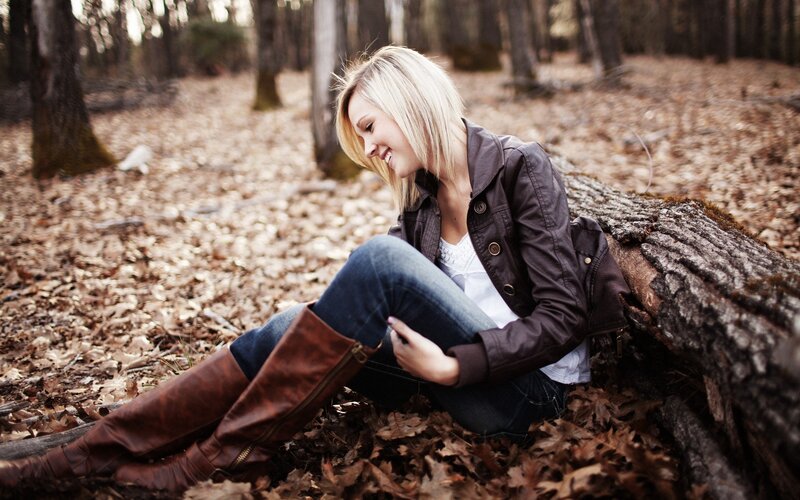 woman sitting in autumn forest