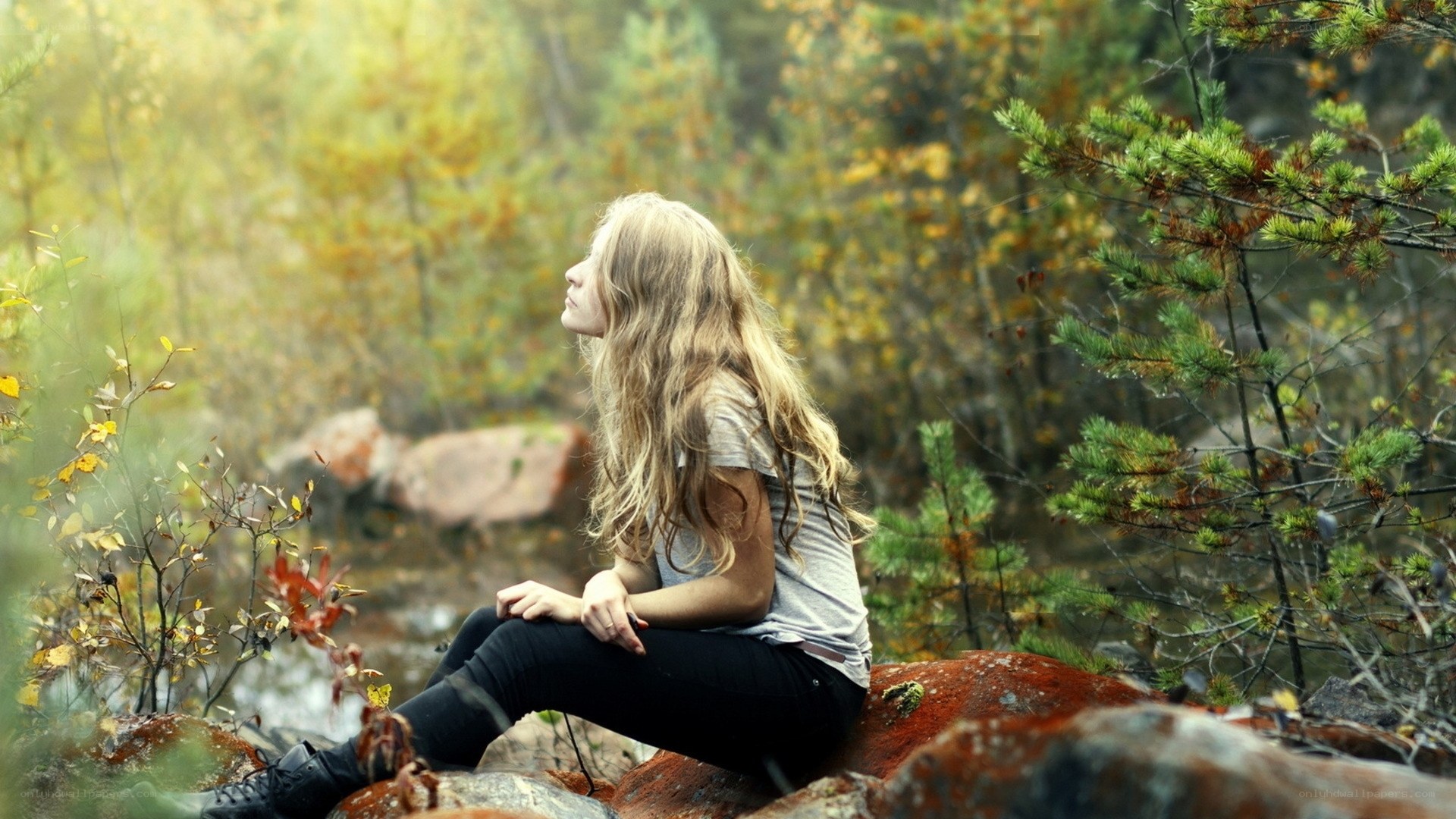 Woman sitting in autumn forest