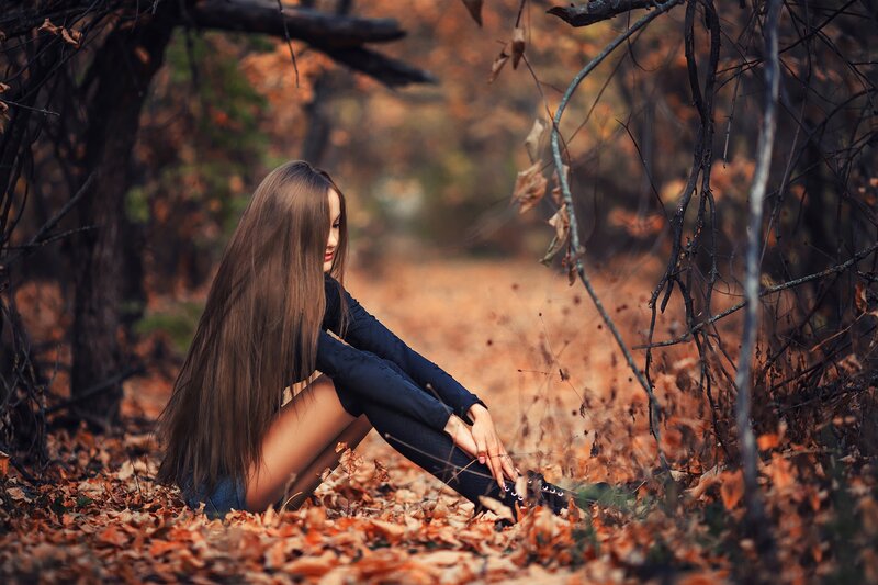 Woman Sitting in Autumn Leaves — Brown, Serene