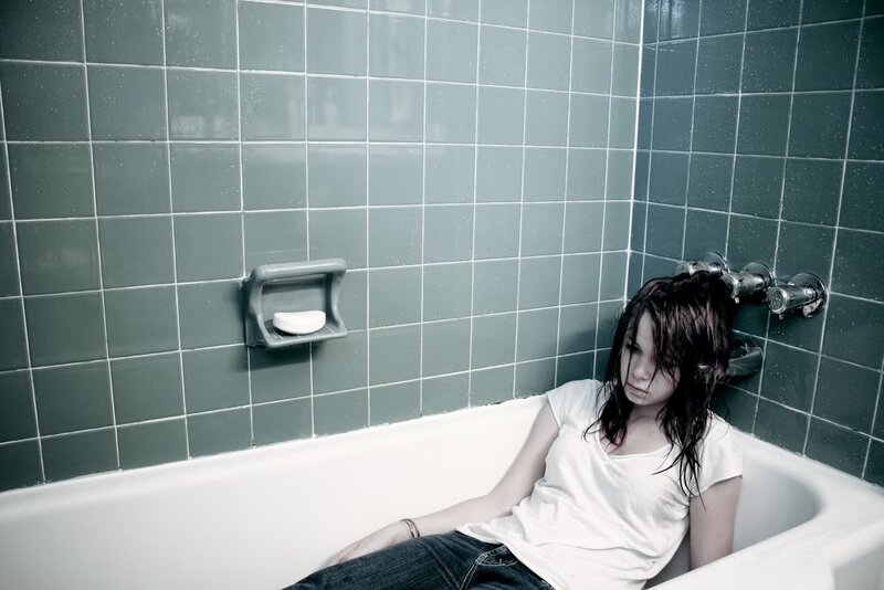woman sitting in bathtub