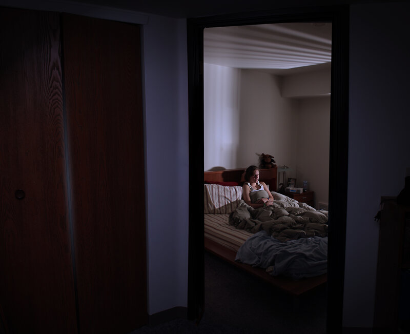 woman sitting in bed at night