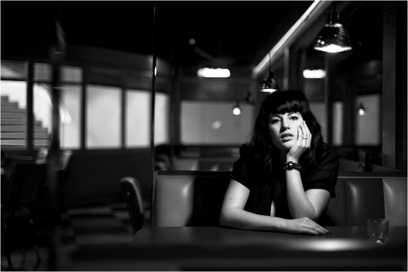 Woman Sitting in Booth