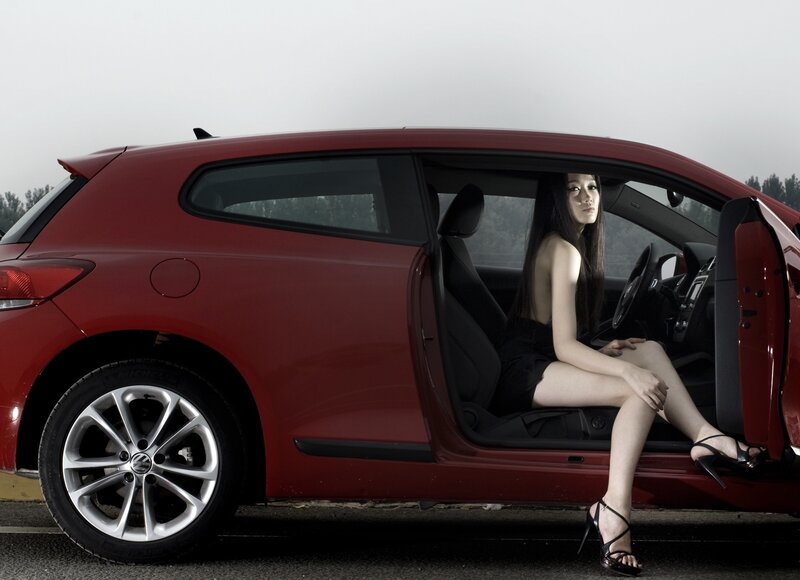Woman Sitting in Car — Red, Dramatic