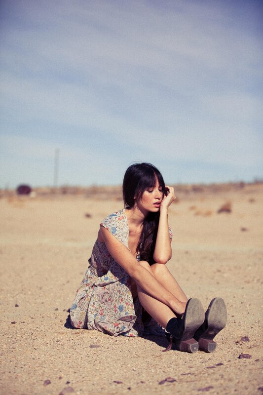 woman sitting in desert