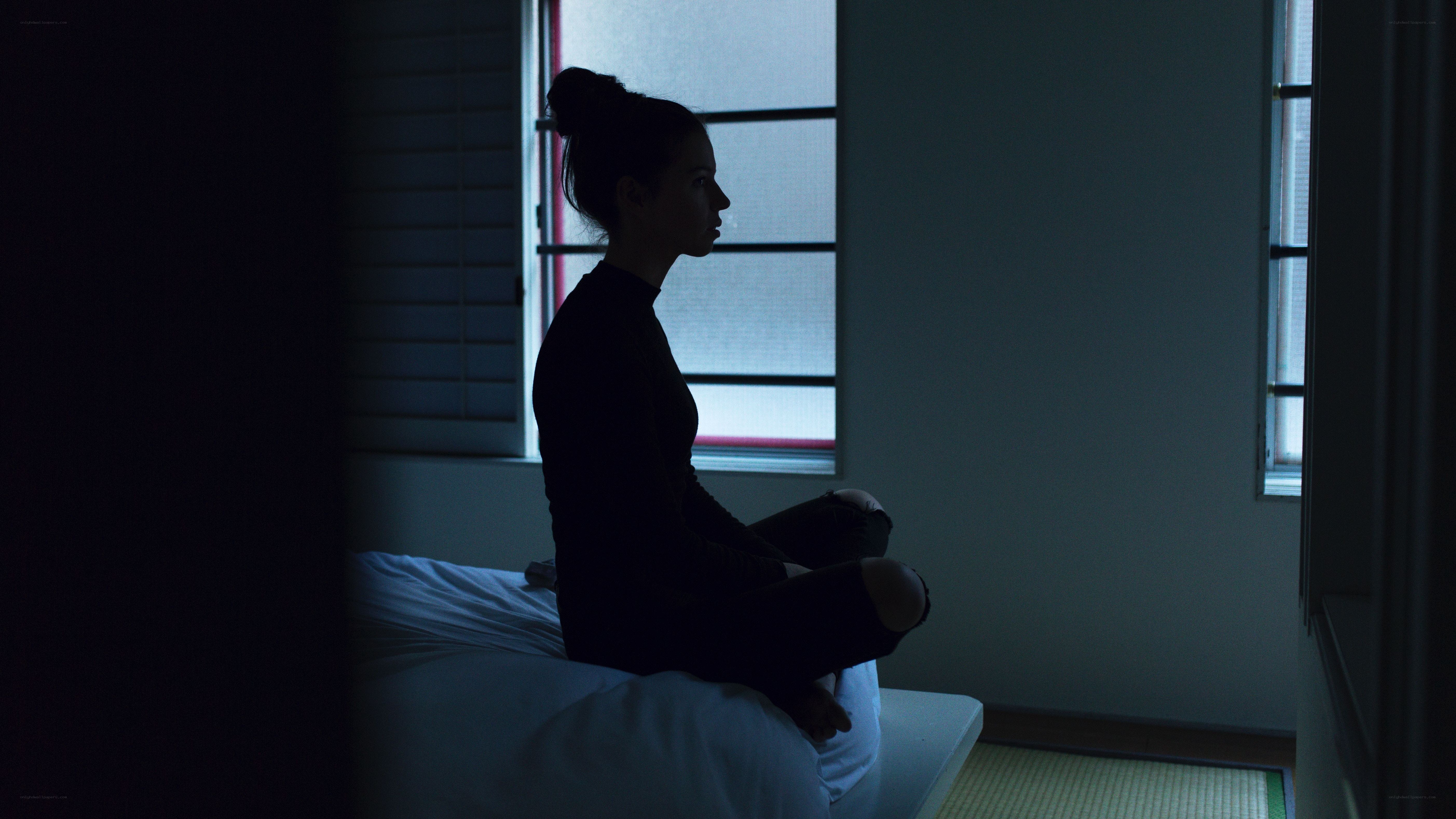 woman sitting in dim light