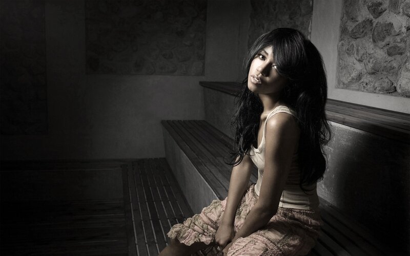 woman sitting in dimly lit room