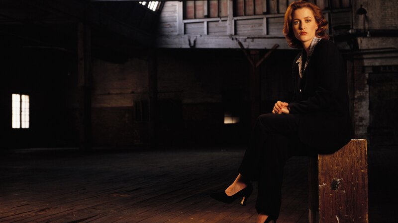 woman sitting in dimly lit warehouse