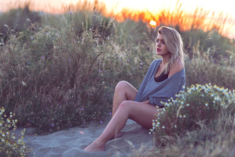 Woman Sitting in Dunes
