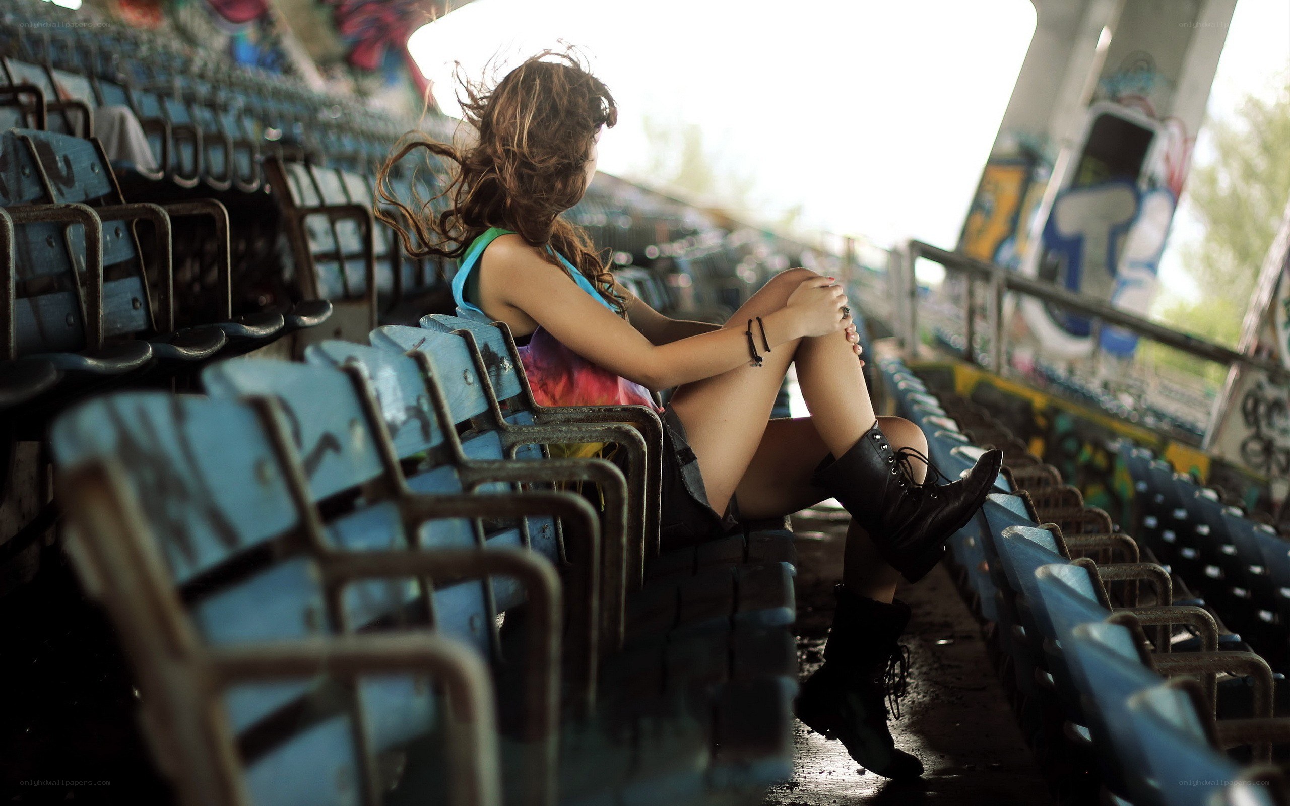 woman sitting in empty stadium