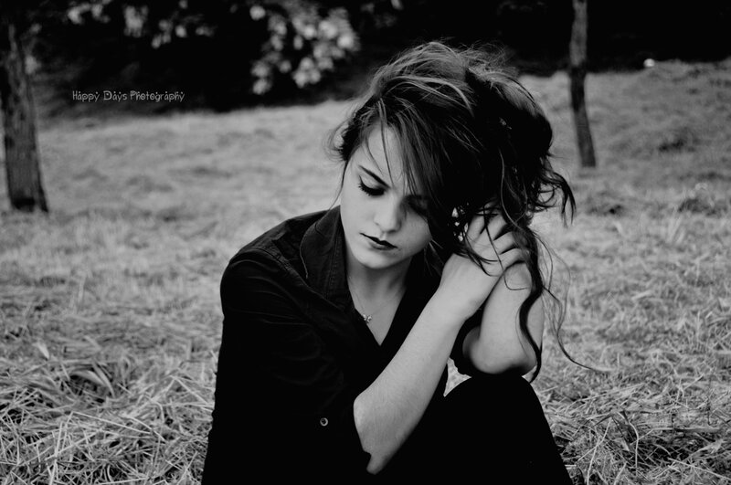 Woman Sitting in Field — Black, Melancholic