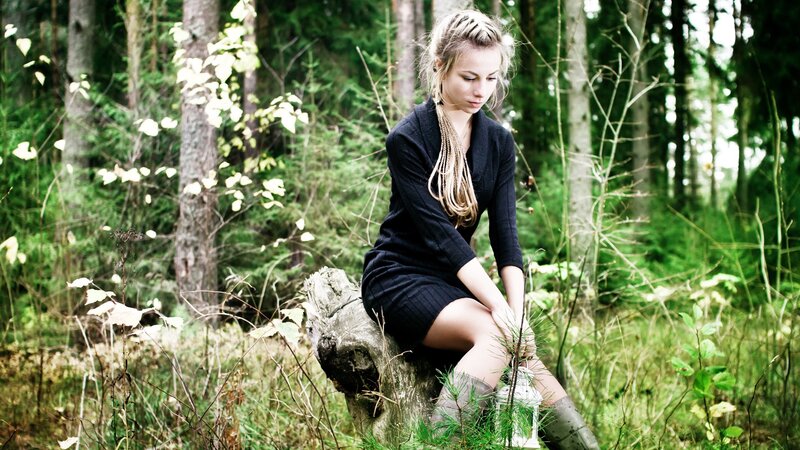 woman sitting in forest