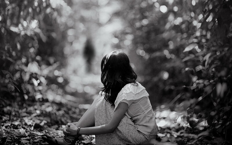 Woman Sitting in Forest — Black, Serene