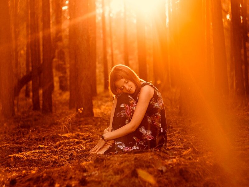 Woman Sitting in Forest — Orange