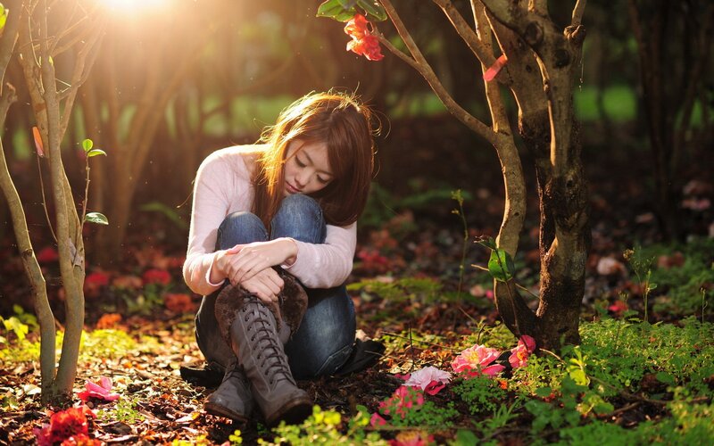 woman sitting in garden at sunset