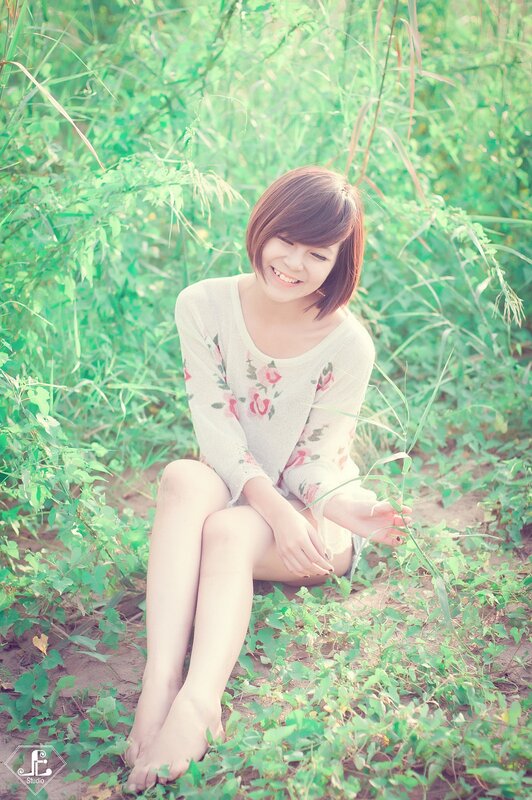woman sitting in green grass