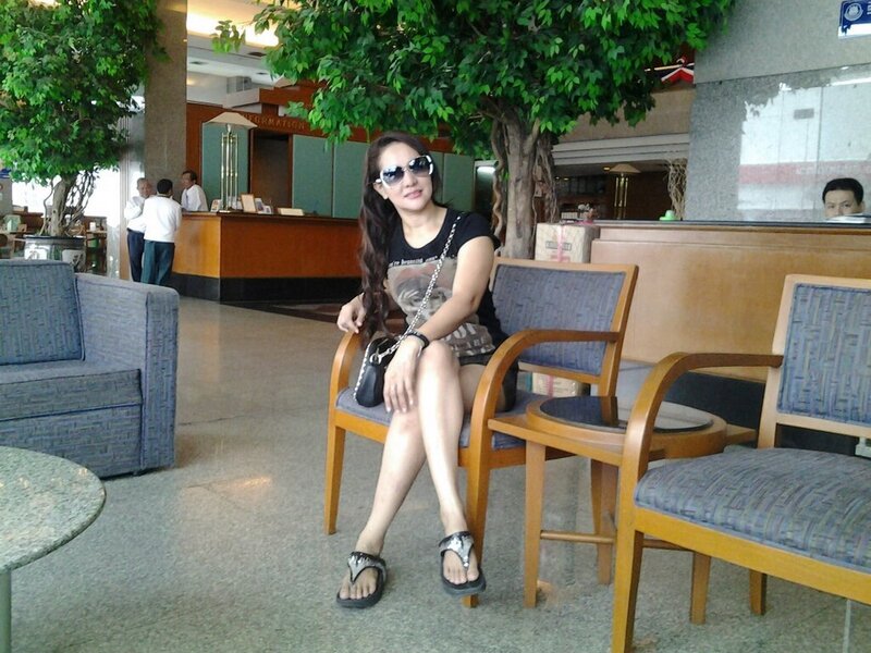 Woman Sitting in Lobby — Green