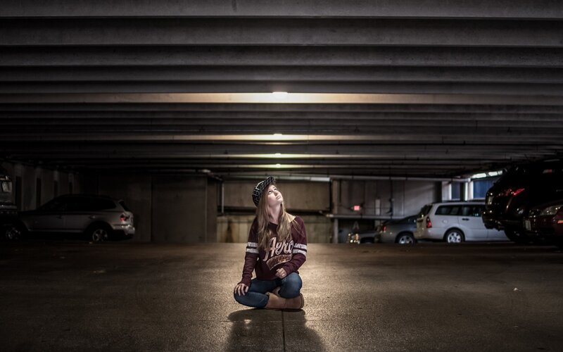 woman sitting in parking garage