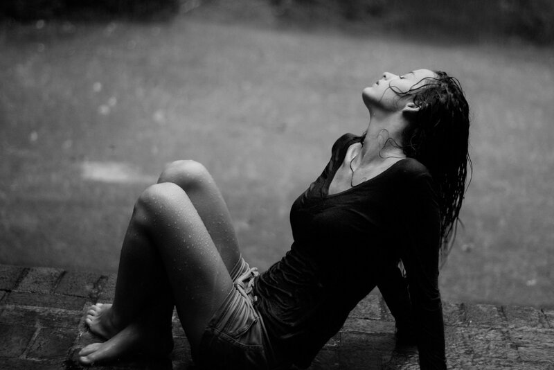 Woman Sitting in Rain — Black