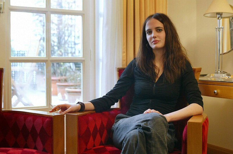 woman sitting in red armchair