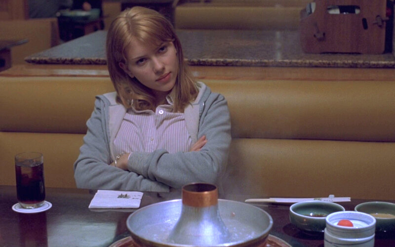 woman sitting in restaurant booth