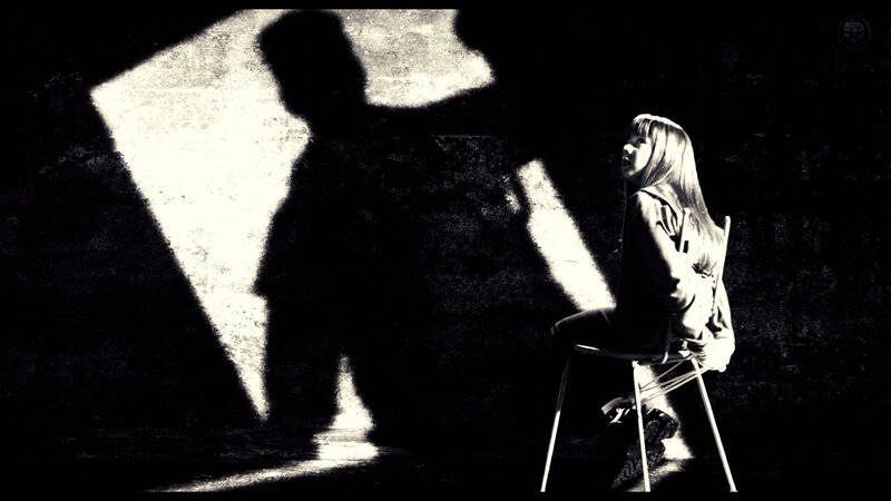 woman sitting in shadow