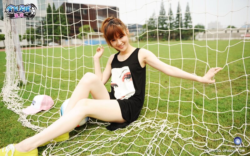 woman sitting in soccer net