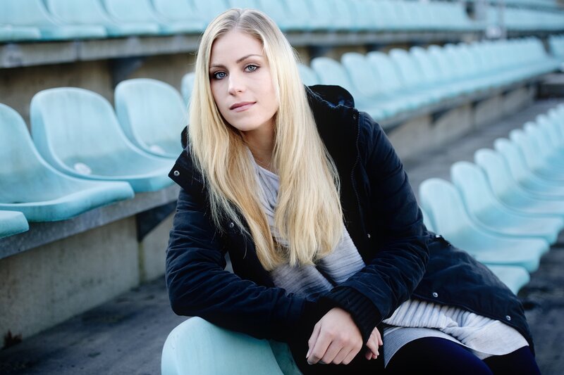 woman sitting in stadium seats