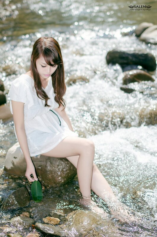 Woman Sitting in Stream