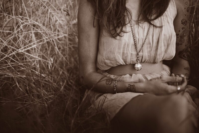 woman sitting in tall grass