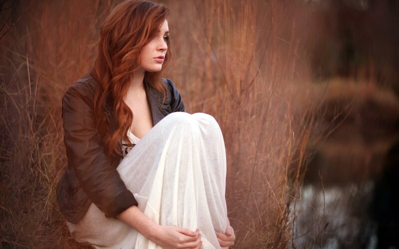 woman sitting in tall grass