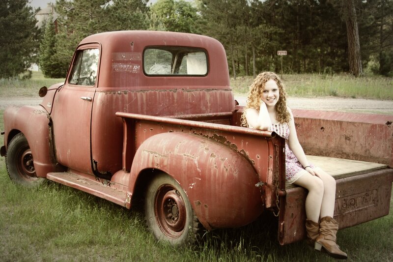 Woman Sitting in Truck Bed