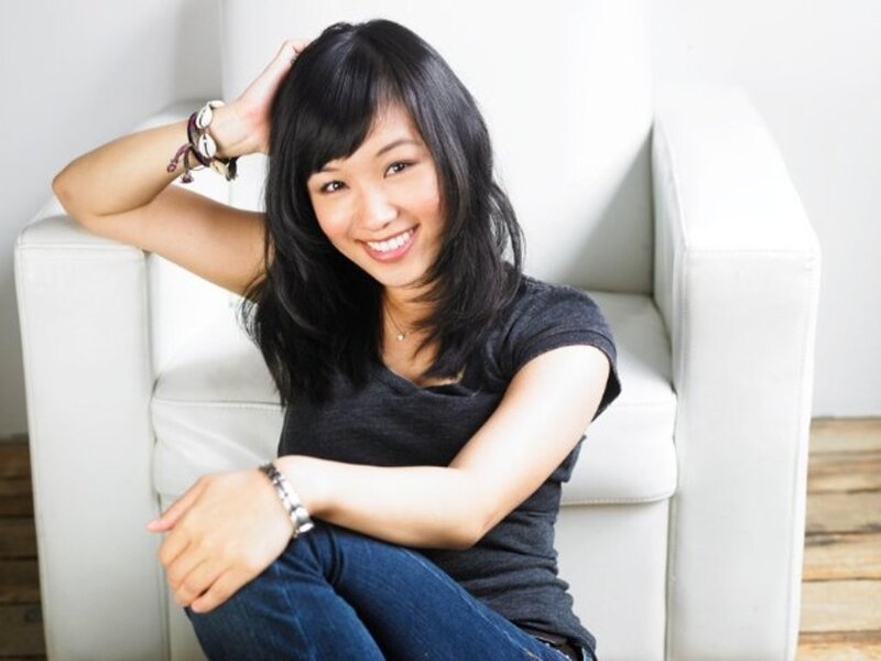 woman sitting in white chair